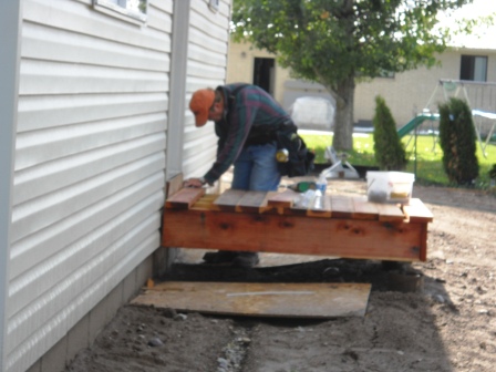 A volunteer builds a back entry.