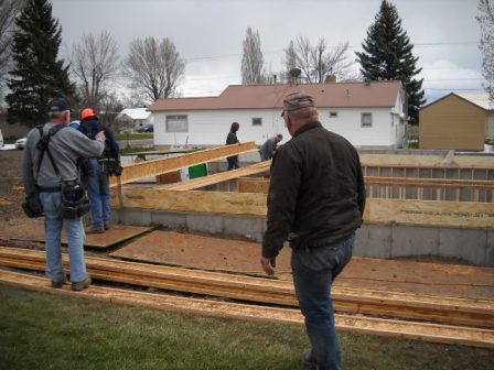 Volunteers placing floor joists