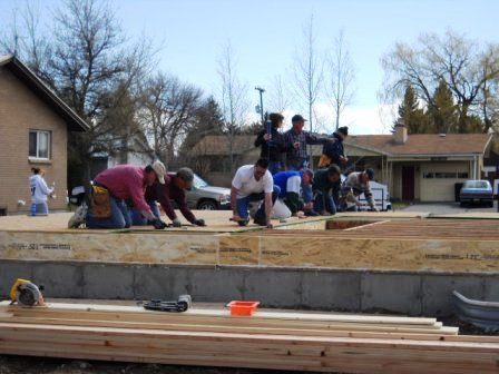 Volunteer work crew nailing down the subfloor
