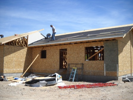 ASME volunteers finish roof sheathing (left)