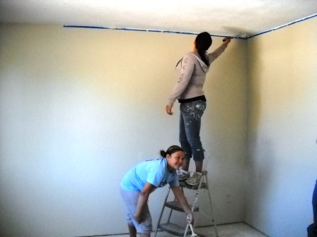 The partner homeowner and her daughter touch up
